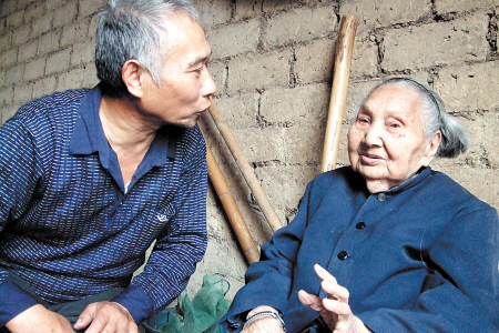 图为百岁老人吴翠英与儿子邹田林在聊天。