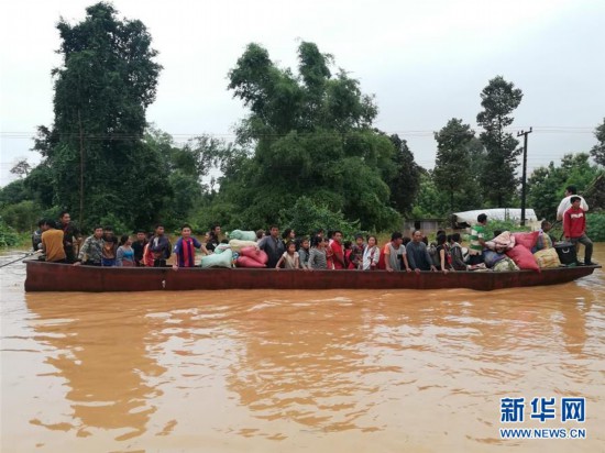 7月24日，在老挝阿速坡，居民乘船撤离被洪水淹没的区域。 