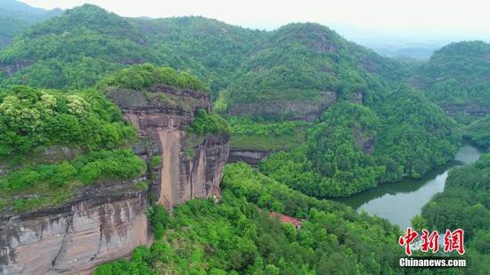 4月24日，航拍江西瑞金罗汉岩。从高空看，罗汉岩风景奇秀，山水相依、碧潭似镜、悬崖峭壁、峰奇石怪、天水合一，令人仿佛走进了一幅浑然天成的山水画卷。江西省瑞金市罗汉岩位于赣闽交界，属武夷山脉西麓，系江西省名山、国家级4A景区，平均海拔500余米，典型的丹霞地貌。 苏明 摄