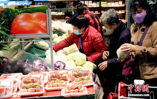 1月27日,农历正月初三,在福州市区一家大型超市,市民戴口罩选购蔬菜。中新社记者 刘可耕 摄 1月27日,农历正月初三,在福州市区一家大型超市,市民戴口罩选购蔬菜。中新社记者 刘可耕 摄
