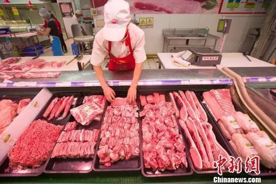 资料图：超市员工在整理猪肉。张云 摄